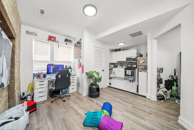 a view of a workspace with furniture and a kitchen