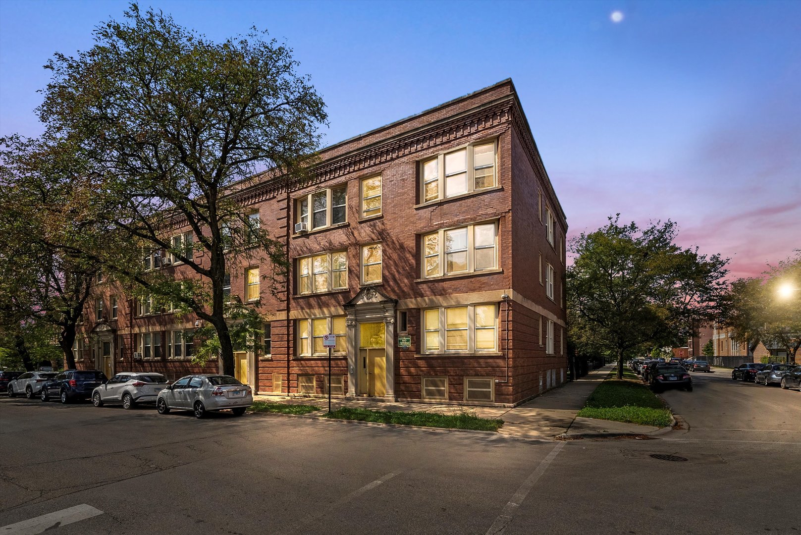 5004 South Champlain Avenue, Unit 1 Chicago, IL 60615 - Photo 15 of 15 a front view of a building with lot of cars and trees