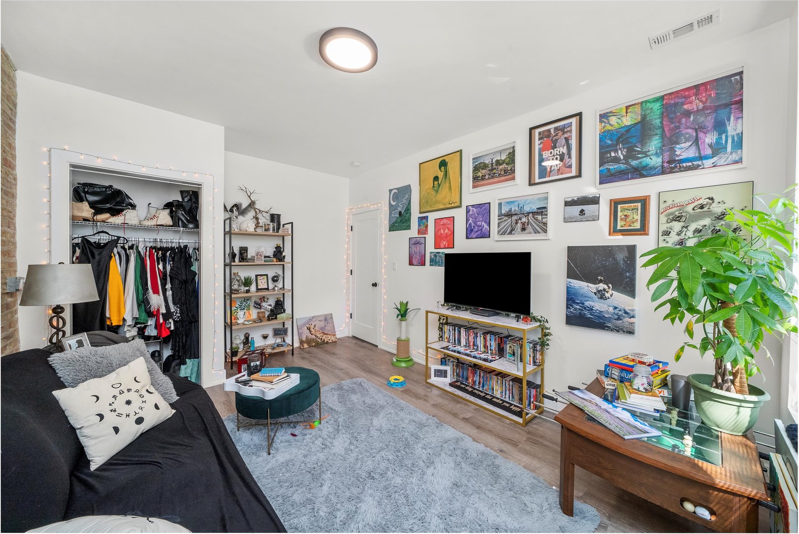 5004 South Champlain Avenue, Unit 1 Chicago, IL 60615 - Photo 3 of 15 a living room with furniture and a flat screen tv
