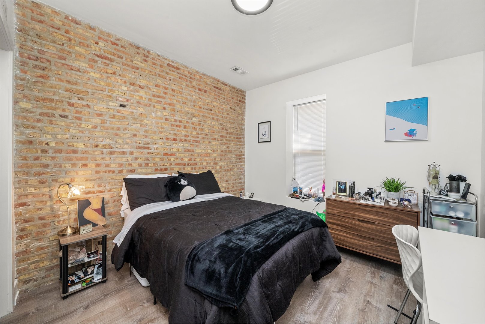 5004 South Champlain Avenue, Unit 1 Chicago, IL 60615 - Photo 4 of 15 a bedroom with a bed and a couch