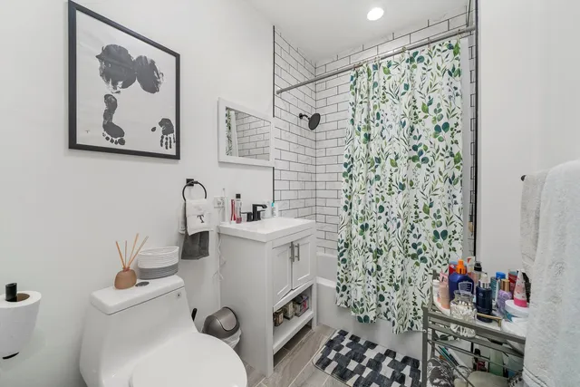 a bathroom with a sink toilet and a shower
