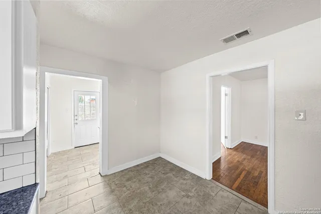 a view of room with window and hallway