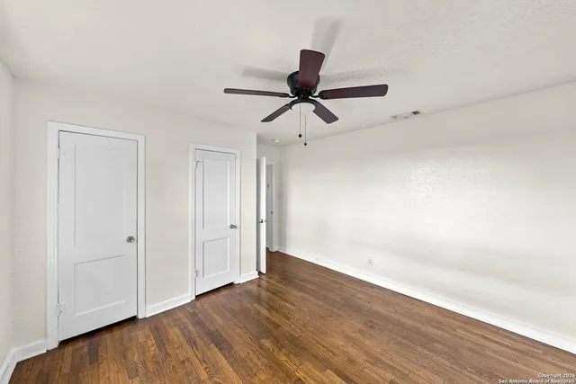 a view of a room with wooden floor and white walls