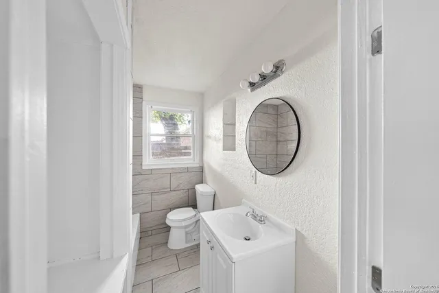 a bathroom with a toilet and a sink