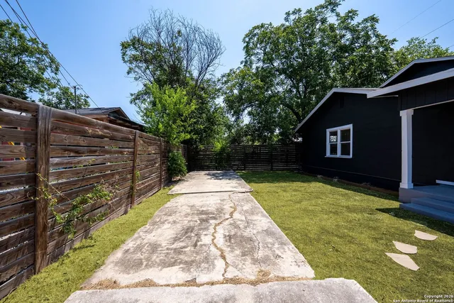 a view of a backyard with pathway