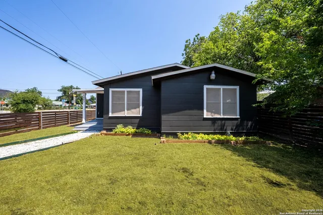 a backyard of a house with yard and outdoor seating