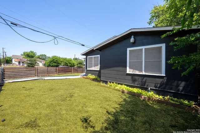 a view of a house with pool and a yard