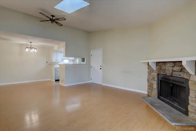 an empty room with a fireplace and fan