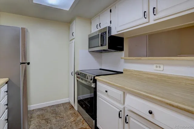 a kitchen with stainless steel appliances a sink stove and microwave