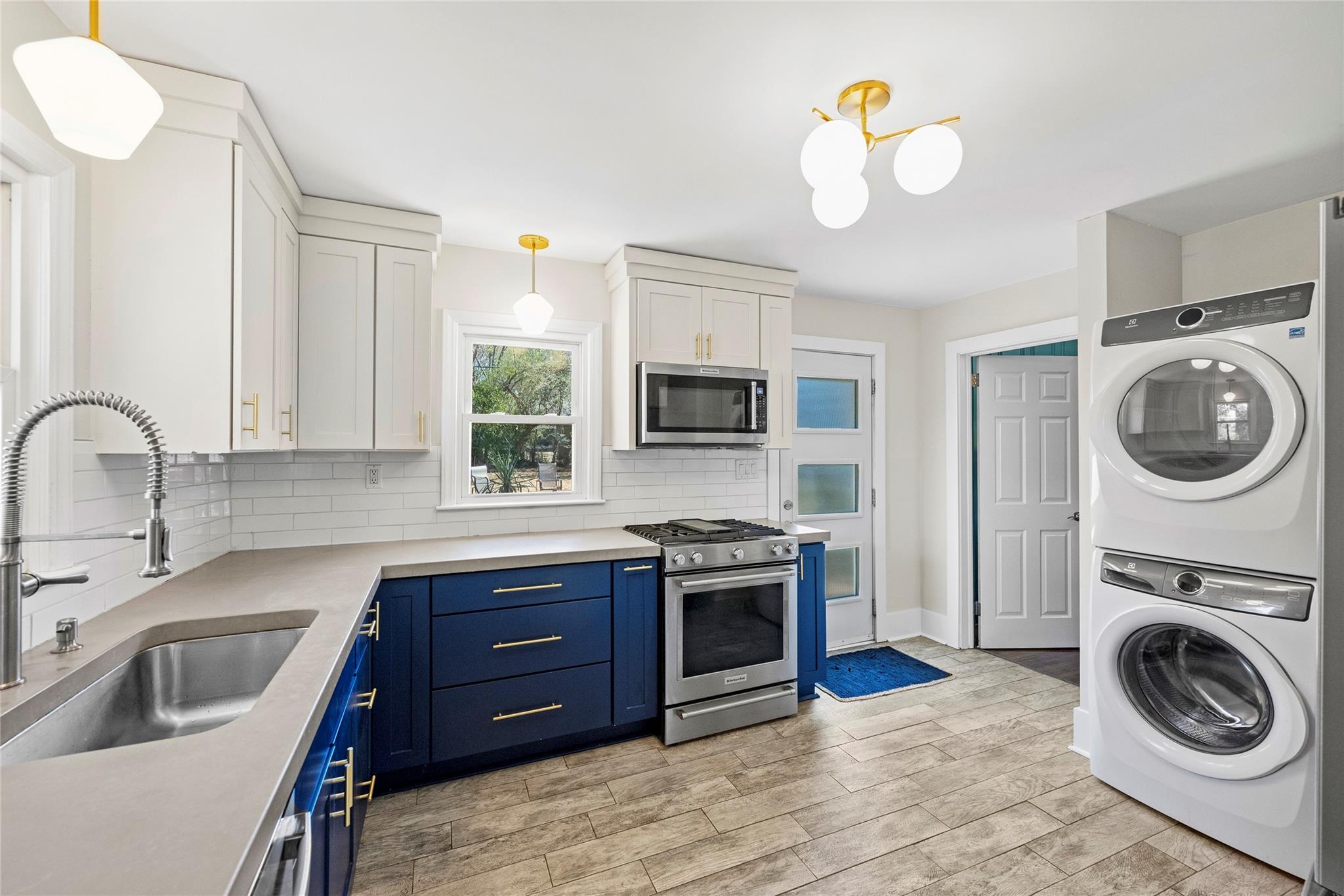 1114 Norland Road Charlotte, NC 28205 - Photo 15 of 36 a kitchen with stainless steel appliances granite countertop a sink and a stove top oven