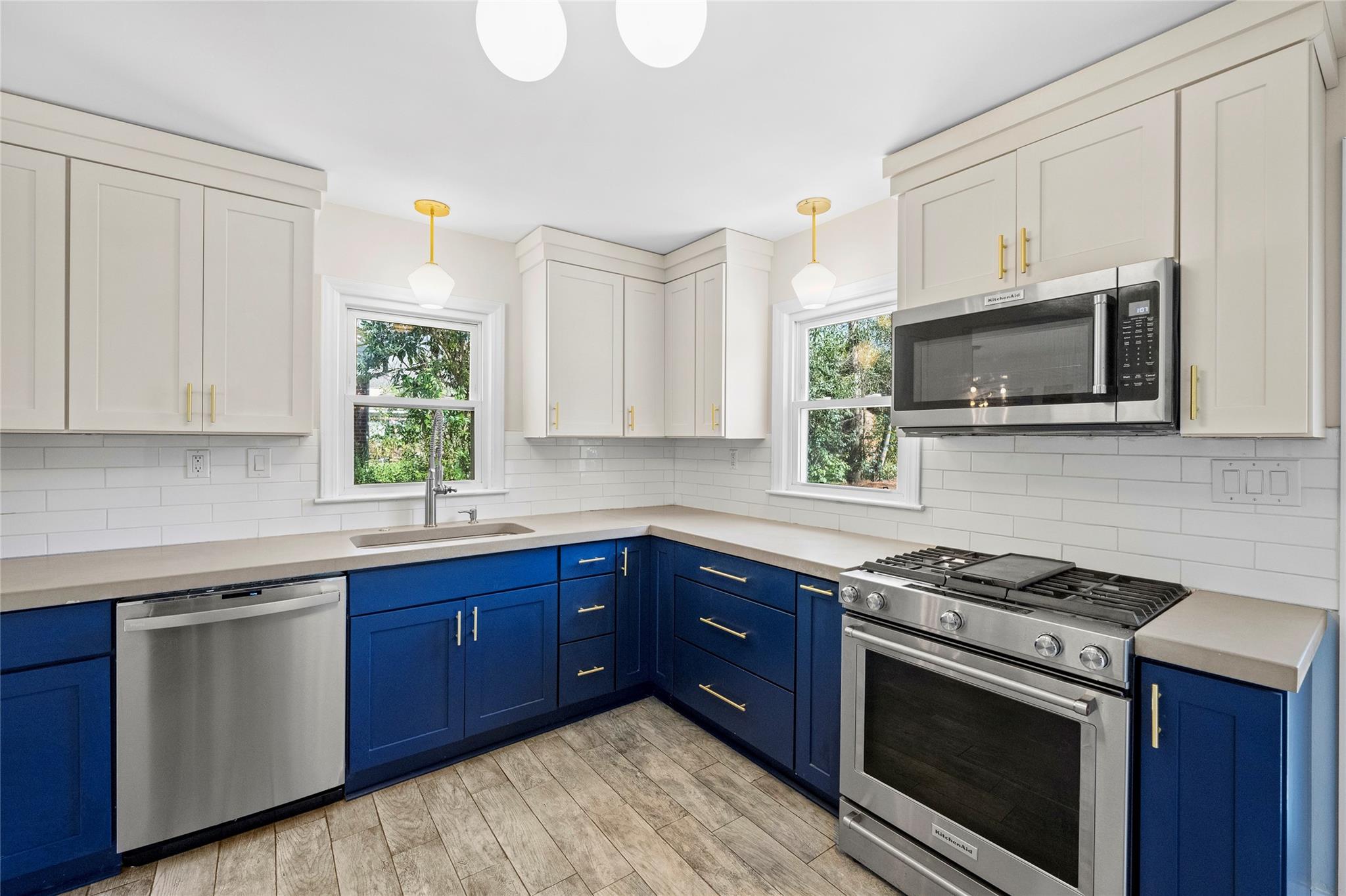 1114 Norland Road Charlotte, NC 28205 - Photo 18 of 36 a kitchen with stainless steel appliances a sink dishwasher stove and microwave