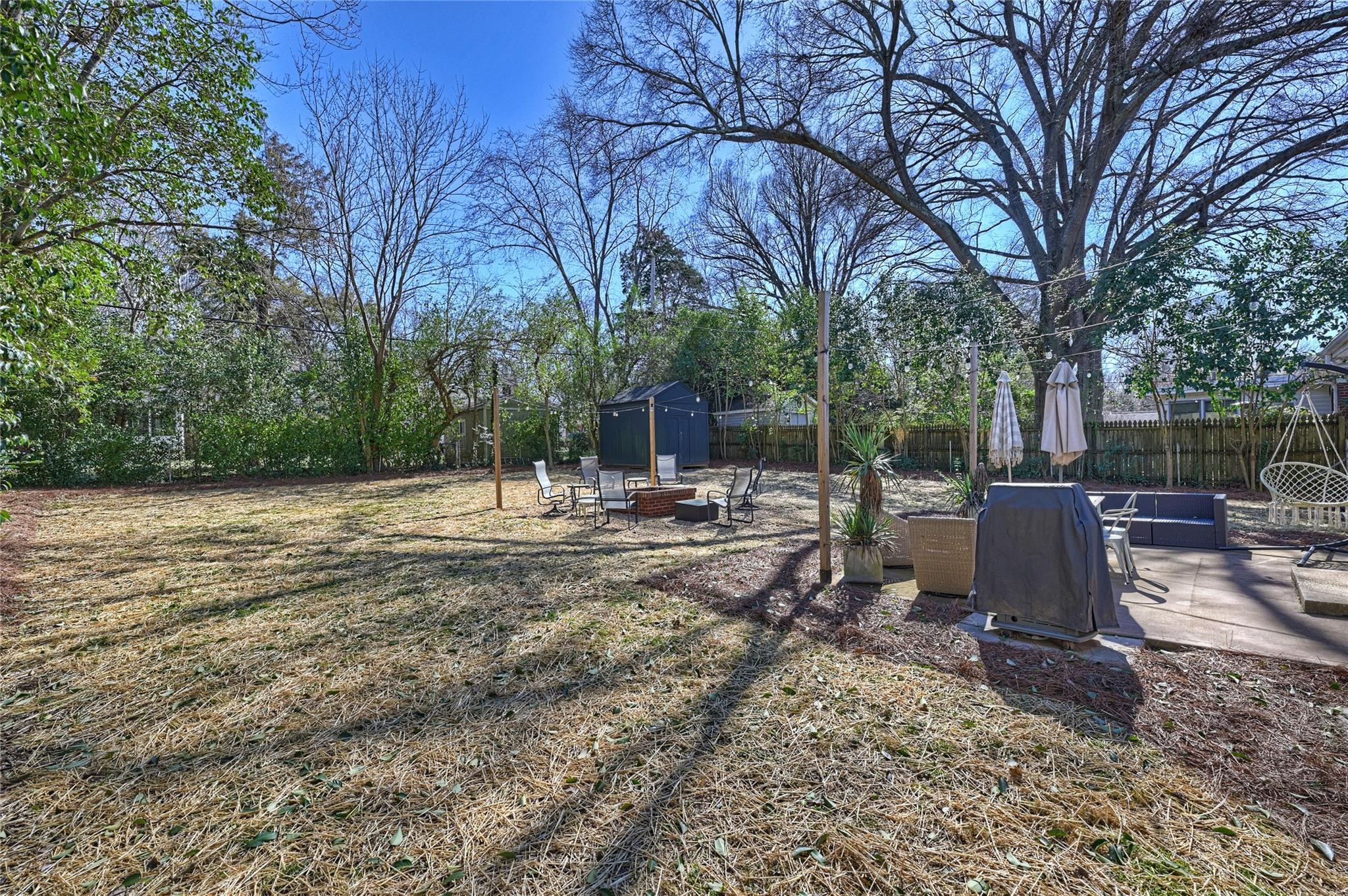 1114 Norland Road Charlotte, NC 28205 - Photo 35 of 36 a view of a backyard with table and chairs and a fire pit