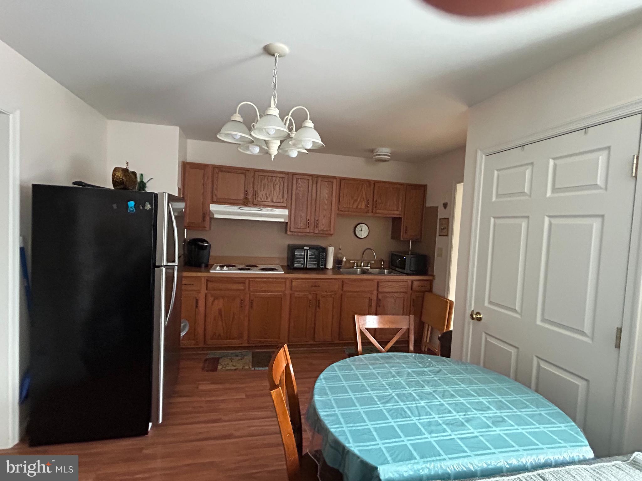 728 Mountain Road Boyertown, PA 19512 - Photo 19 of 26 a kitchen with a table chairs refrigerator and microwave