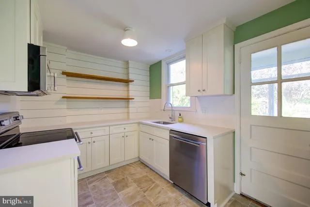 a kitchen with sink cabinets and window