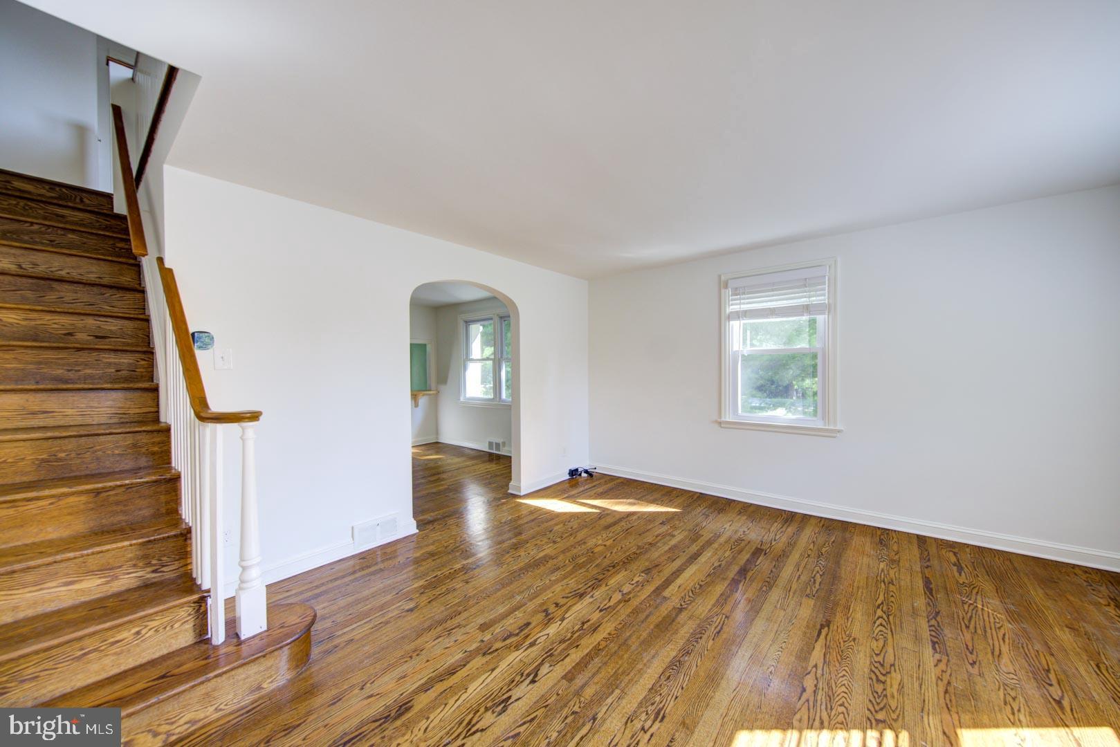 273 South Devon Avenue Wayne, PA 19087 - Photo 3 of 32 a view of an empty room with wooden floor and stairs
