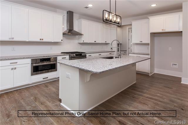 5345 State Rd S-46-557 Clover, SC 29710 - Photo 4 of 5 a kitchen with stainless steel appliances granite countertop a sink stove and white cabinets