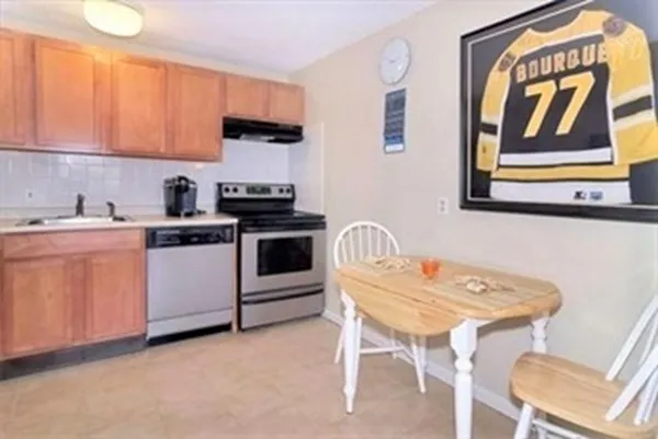 a kitchen with a sink cabinets and appliances