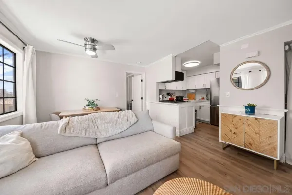 a living room with furniture and kitchen view