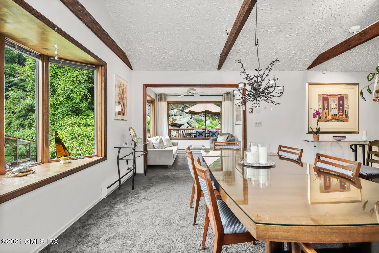 53 Dagmar Road Stamford, CT 06905 - Photo 7 of 36 a dining room with furniture a large window and a chandelier