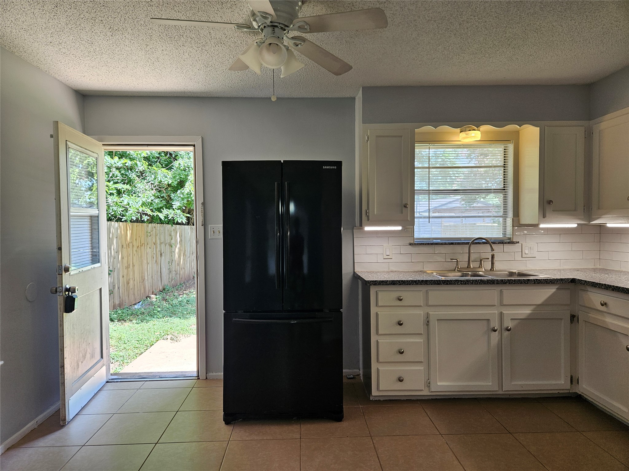 806 Ranch Road, Unit A Georgetown, TX 78628 - Photo 6 of 24 A well-equipped kitchen features a functional layout and outdoor access for effortless entertaining.