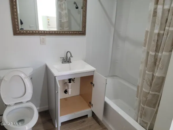 a bathroom with a sink a toilet and a bathtub