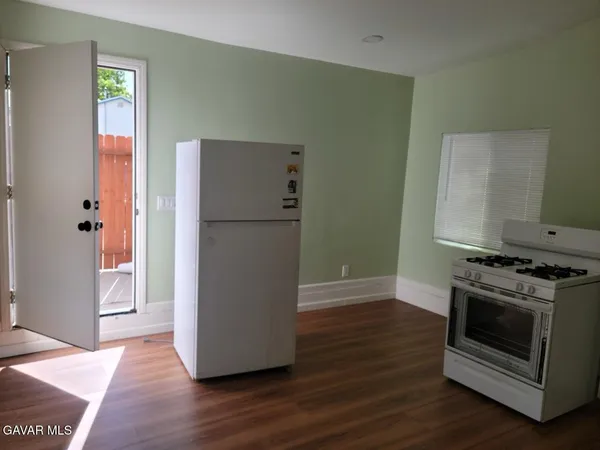 a kitchen with a stove and a refrigerator