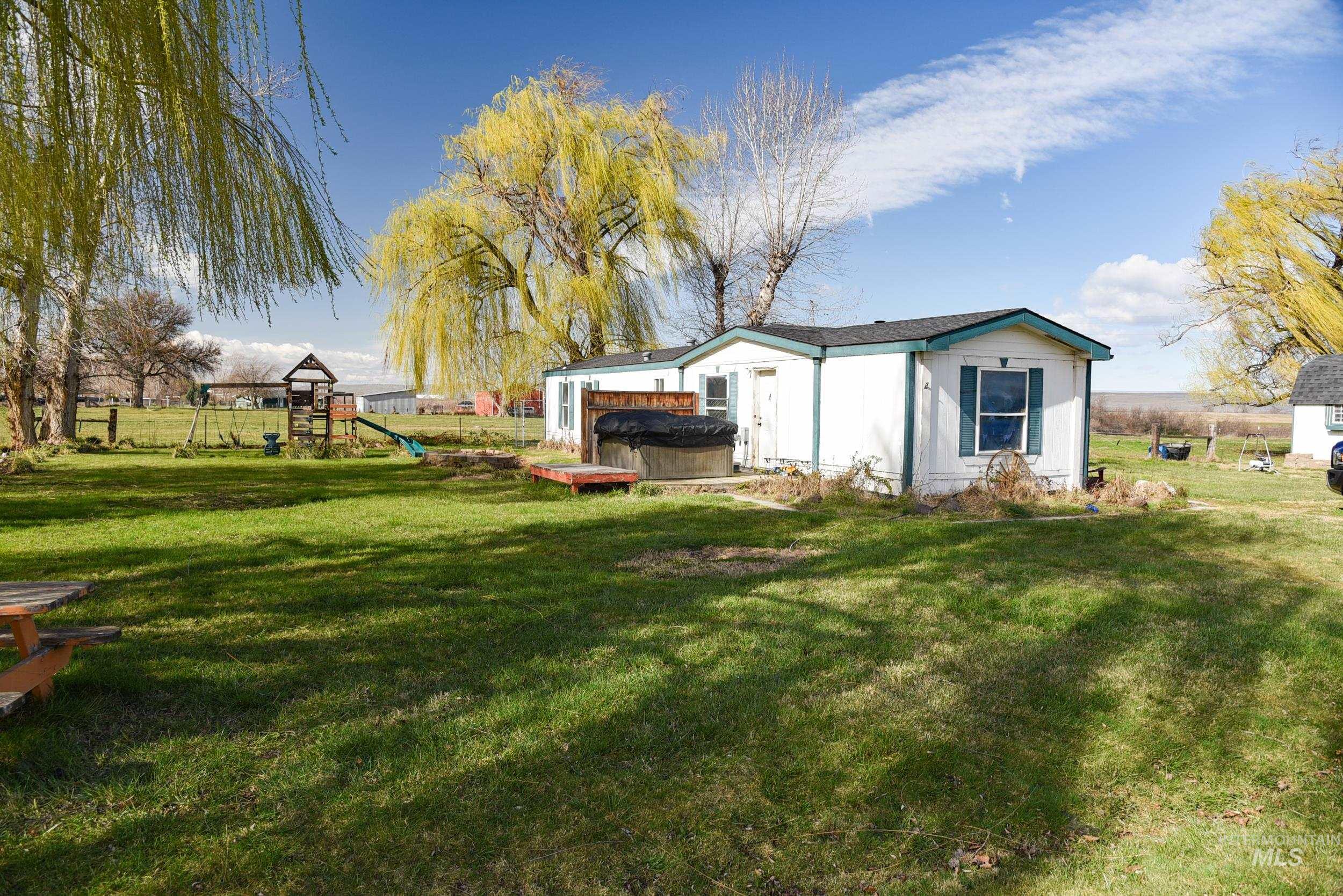 Undisclosed Address Boardman, OR 97818 - Photo 5 of 13 View of yard featuring a playground and a hot tub