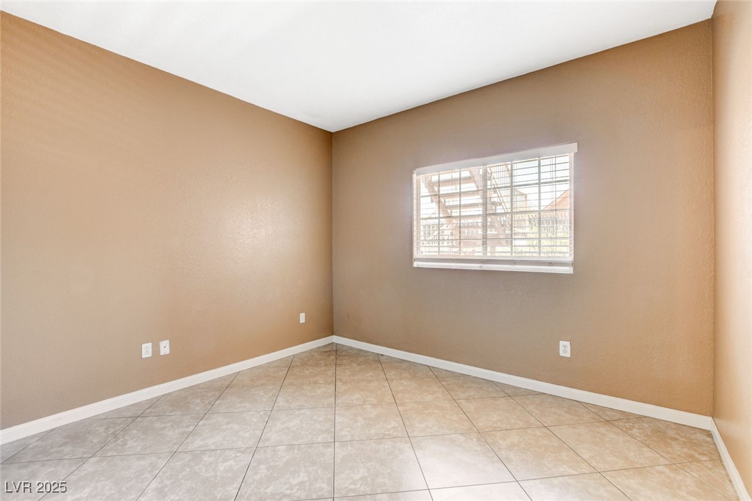 4730 East Craig Road, Unit 1005 Las Vegas, NV 89115 - Photo 19 of 45 Empty room featuring light tile patterned floors and baseboards