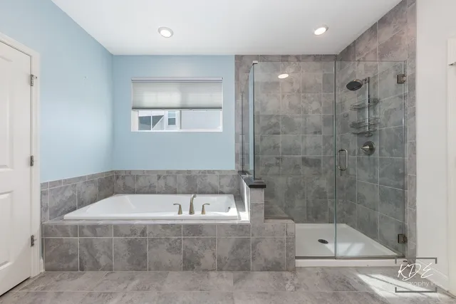 a bathroom with a bathtub and shower