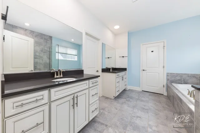 a kitchen with white cabinets and a sink