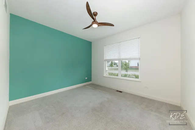 a view of room with window and ceiling fan