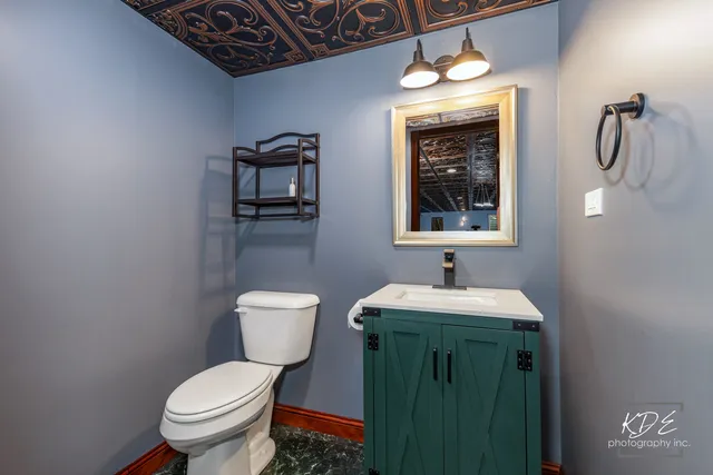 a bathroom with a toilet sink and mirror