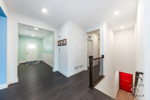 an empty room with wooden floor and closet