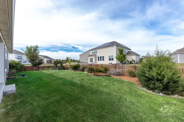 a view of a chair and table in backyard