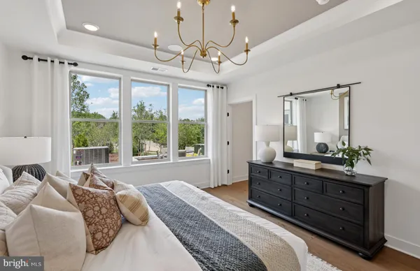 a bedroom with a bed and a chandelier