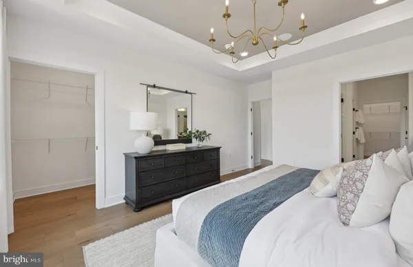 a spacious bedroom with a large bed and a window