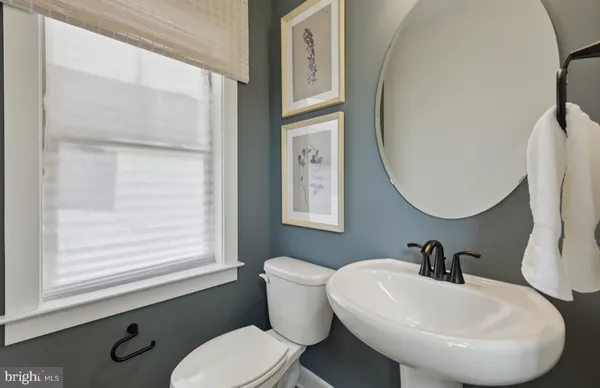 a bathroom with a toilet a sink and mirror