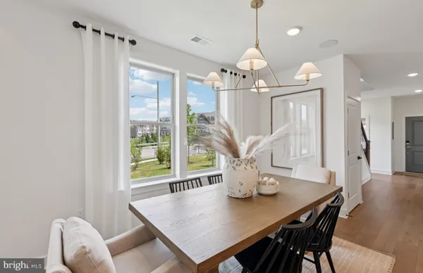 a view of a dining room with furniture and a chandelier