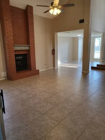 a view of an empty room with a fireplace