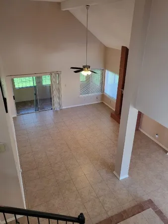 a view of a room with wooden floor and a window