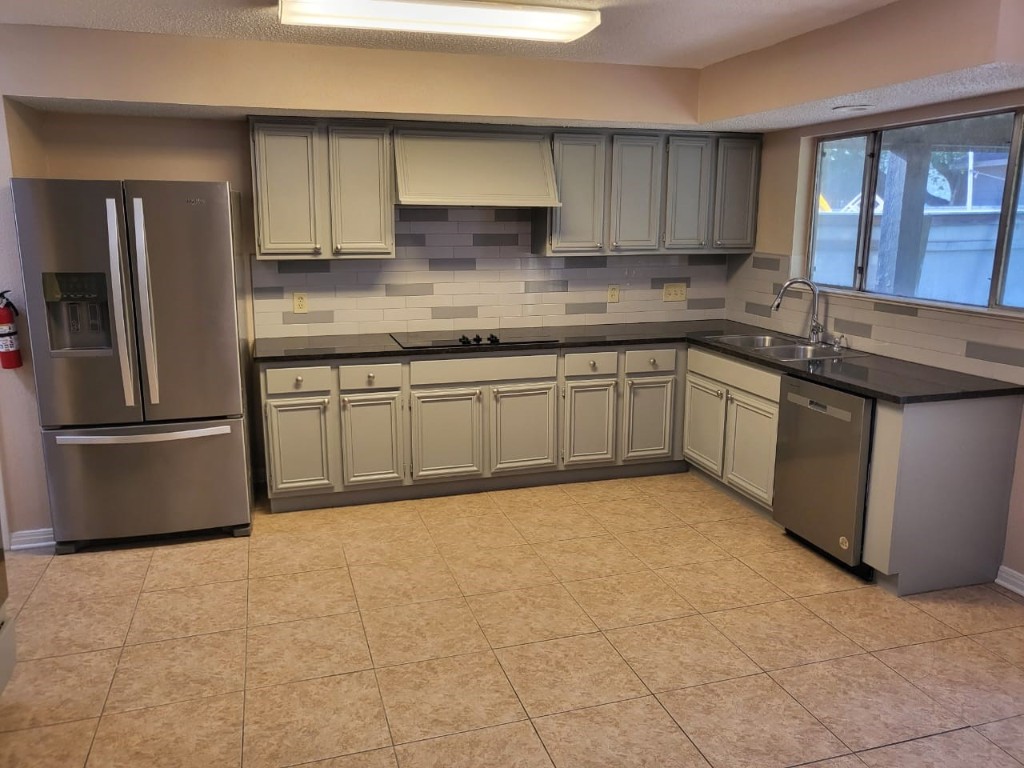 14810 Rancho Vista Drive Houston, TX 77083 - Photo 17 of 33 a kitchen with stainless steel appliances granite countertop a sink stove and refrigerator