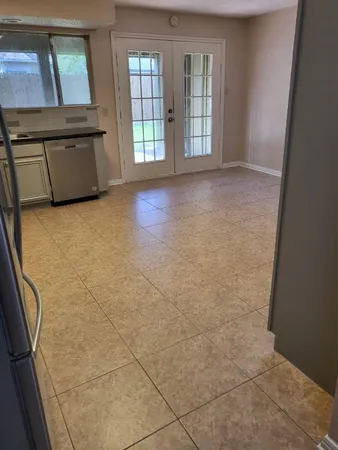a kitchen with stainless steel appliances a refrigerator sink and cabinets