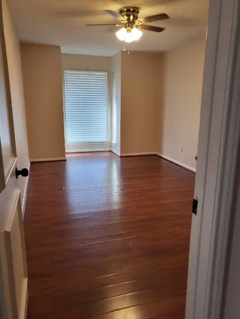 a view of closet with wooden floor