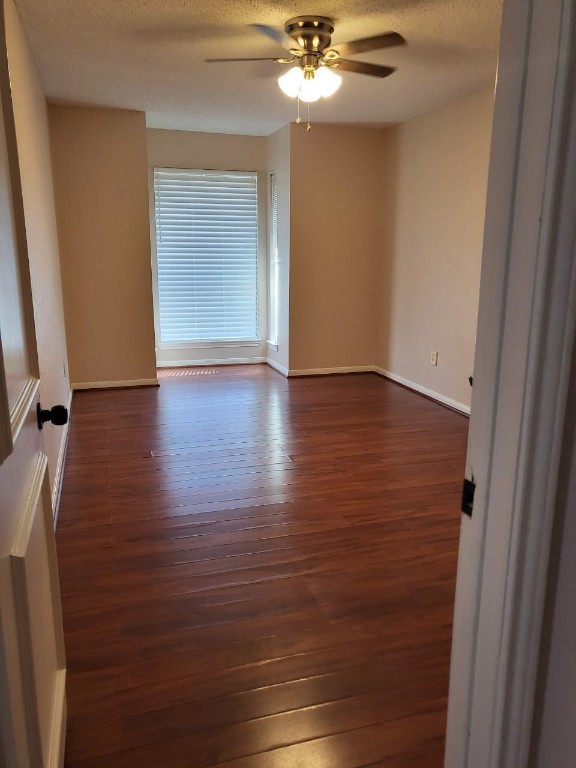 14810 Rancho Vista Drive Houston, TX 77083 - Photo 22 of 33 a view of an empty room with wooden floor and fan