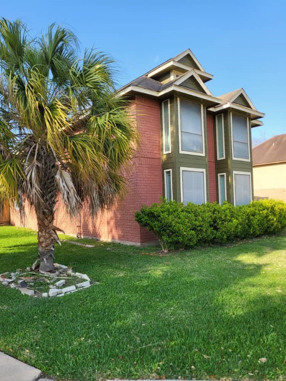 14810 Rancho Vista Drive Houston, TX 77083 - Photo 5 of 33 a front view of a house with a garden