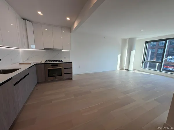 a large kitchen with stainless steel appliances granite countertop a stove a sink and a refrigerator