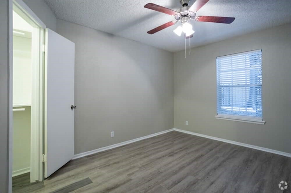 6505 Westheimer Road, Unit 114 Houston, TX 77057 - Photo 12 of 16 wooden floor in an empty room with a window