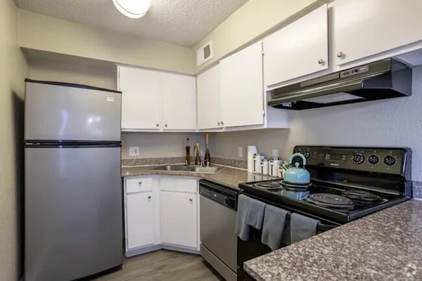 a kitchen with a stove and a refrigerator