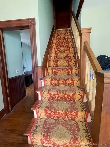 a kitchen with granite countertop a refrigerator and a stove top oven