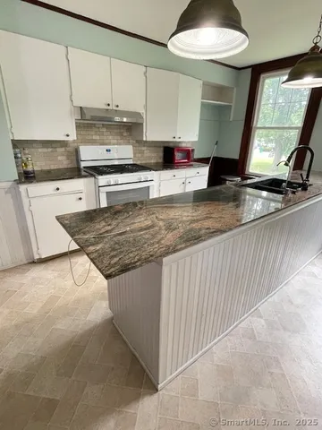 a outdoor dining table with chairs and window